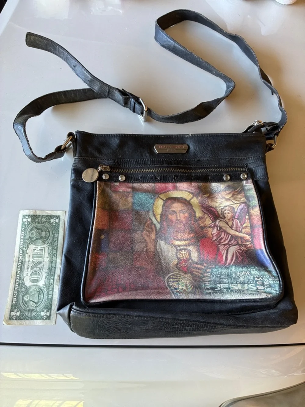 Black Crossbody Leather Bag with Religious Print on outside and floral print in